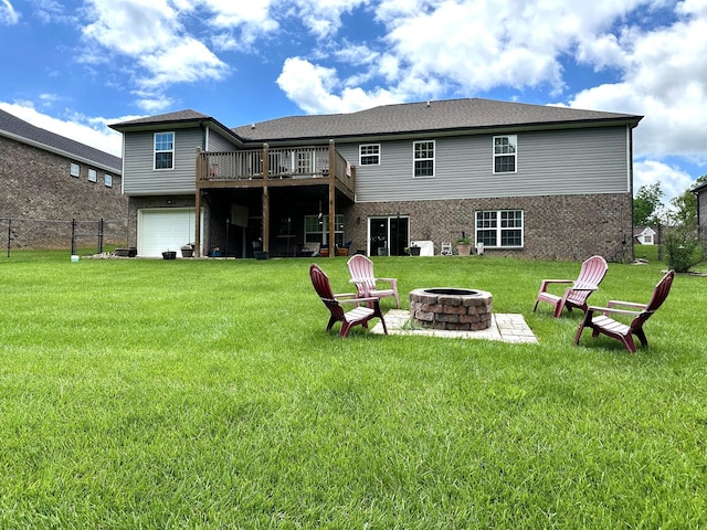 back of house with a fire pit, a deck, brick siding, and an attached garage