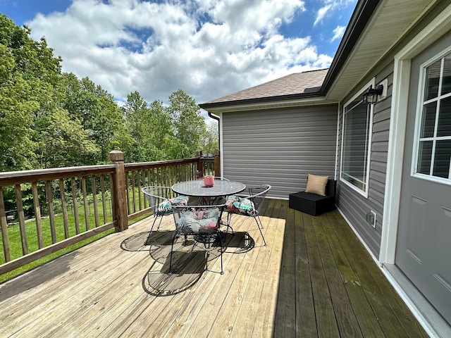 wooden terrace featuring outdoor dining space