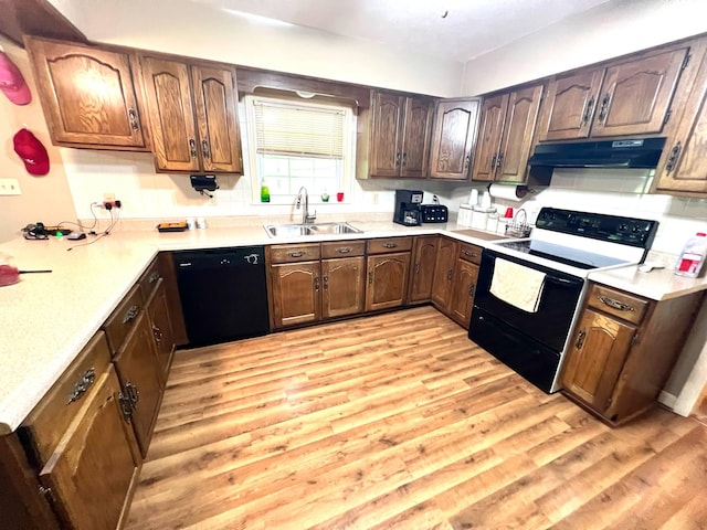4758 Cloverlick Rd, Cumberland, KY 40823 - kitchen with black appliances, a sink, under cabinet range hood, light wood finished floors, and light countertops