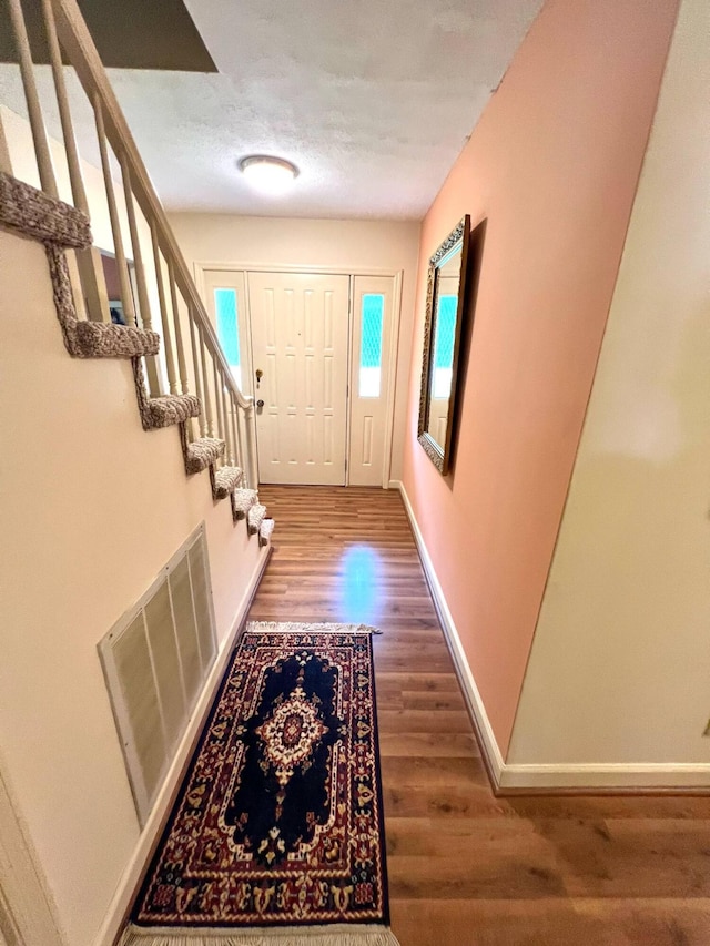4758 Cloverlick Rd, Cumberland, KY 40823 - doorway with wood finished floors, baseboards, and stairway