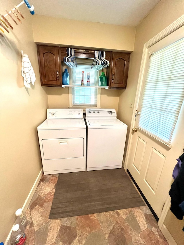 4758 Cloverlick Rd, Cumberland, KY 40823 - laundry area featuring cabinet space, washing machine and clothes dryer, baseboards, and dark stone finish flooring
