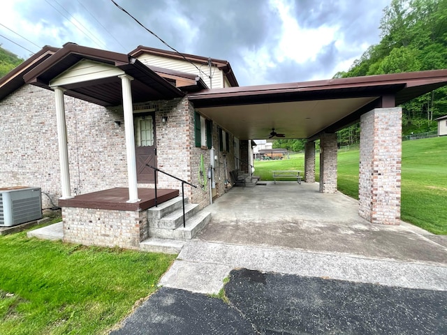 4758 Cloverlick Rd, Cumberland, KY 40823 - view of front of property with central AC, a front lawn, a ceiling fan, and brick siding