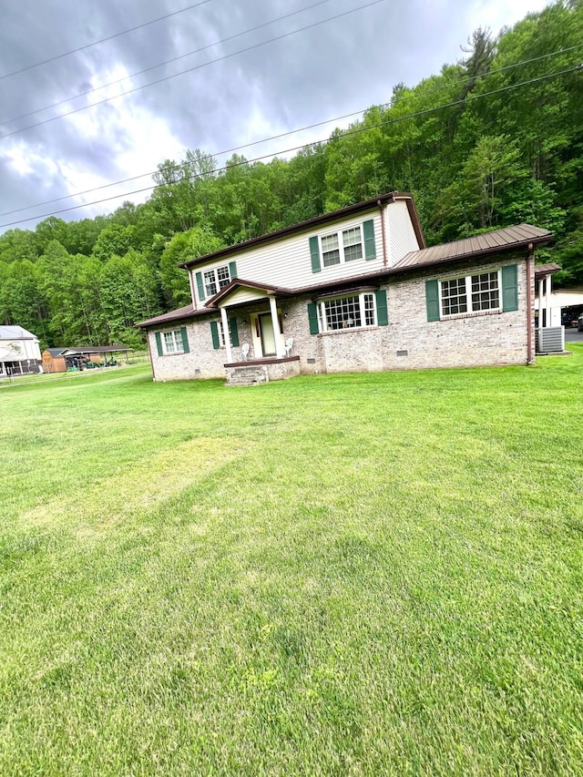4758 Cloverlick Rd, Cumberland, KY 40823 - view of front of house featuring central AC, a front yard, metal roof, and a forest view