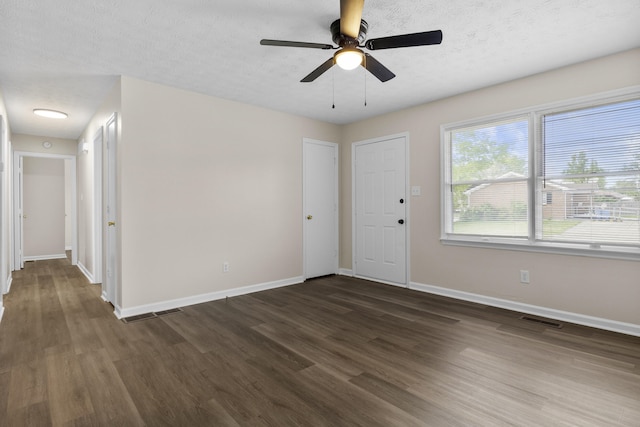 340 Wise Dr, Wilmore, KY 40390 - unfurnished room featuring dark wood-type flooring, baseboards, a ceiling fan, and a textured ceiling