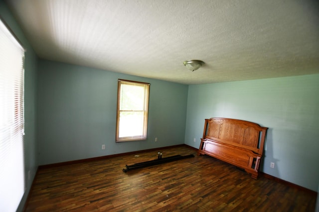 spare room with wood finished floors and baseboards