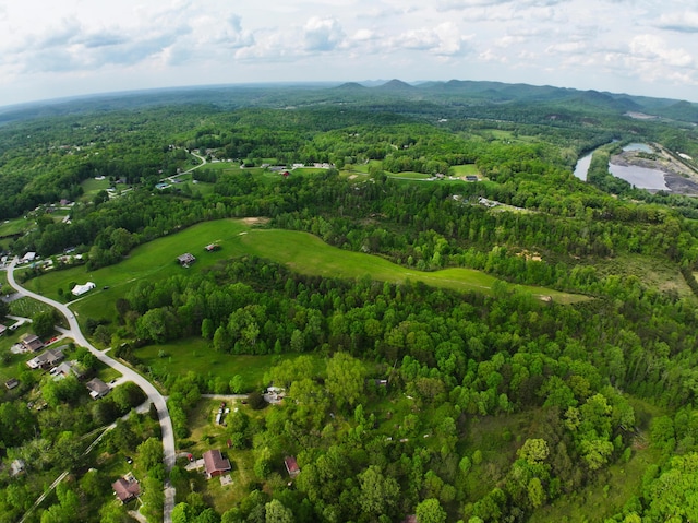 aerial view of property and surrounding area with a forest