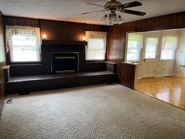 1819 N 27th Hwy, Cynthiana, KY 41031 - unfurnished living room featuring ceiling fan, baseboards, a fireplace, and wood walls