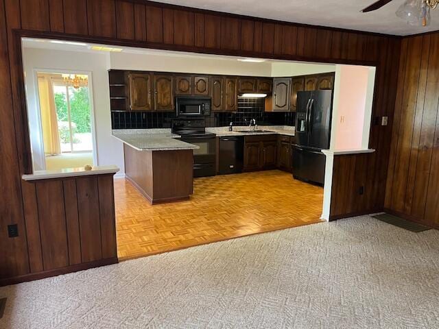 1819 N 27th Hwy, Cynthiana, KY 41031 - kitchen with black appliances, light countertops, wood walls, backsplash, and dark brown cabinetry