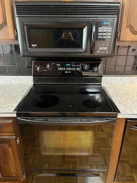 1819 N 27th Hwy, Cynthiana, KY 41031 - kitchen view of black appliances, brown cabinetry, and decorative backsplash