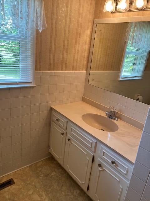 1819 N 27th Hwy, Cynthiana, KY 41031 - bathroom featuring tile walls, vanity, and a wainscoted wall