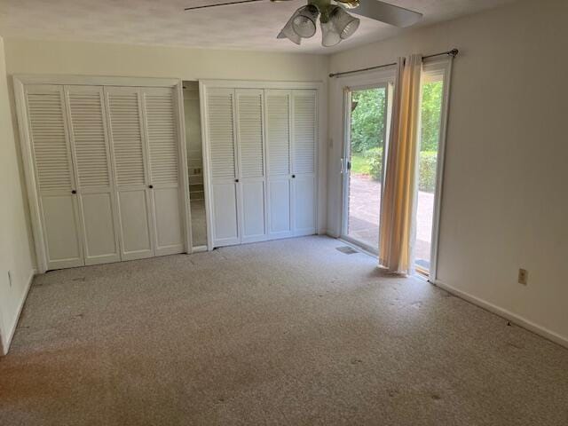 1819 N 27th Hwy, Cynthiana, KY 41031 - unfurnished bedroom featuring access to outside, carpet floors, baseboards, multiple closets, and a ceiling fan