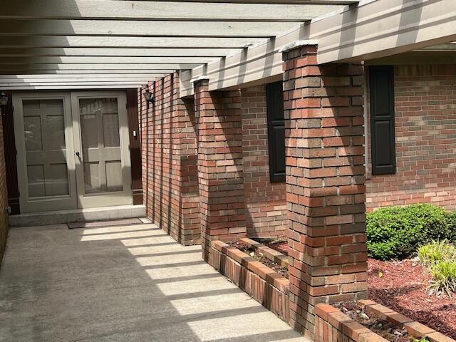 1819 N 27th Hwy, Cynthiana, KY 41031 - view of side of home with brick siding, a pergola, and french doors