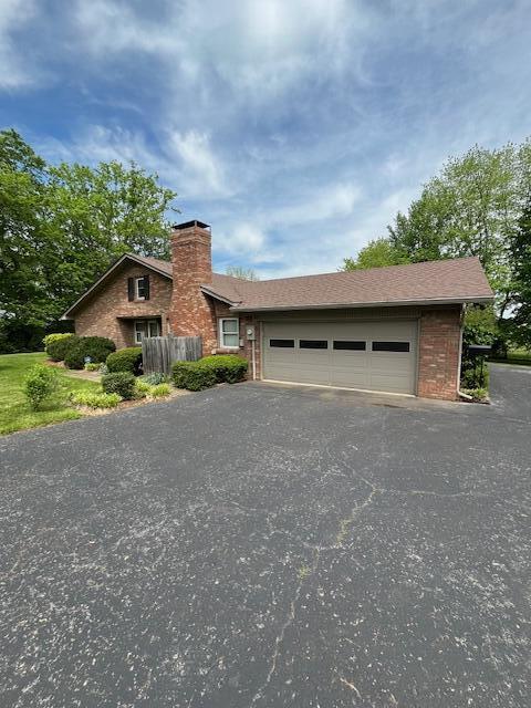 1819 N 27th Hwy, Cynthiana, KY 41031 - mid-century home with driveway, brick siding, an attached garage, and a chimney