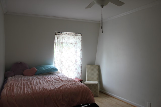 bedroom featuring ornamental molding, light wood-style flooring, baseboards, and ceiling fan