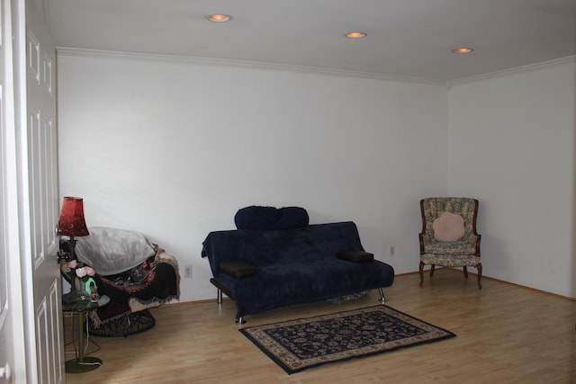 living area featuring ornamental molding, wood finished floors, recessed lighting, and baseboards