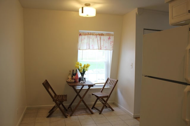 dining room featuring baseboards and light tile patterned floors