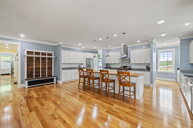 324 Hays Mays Rd, Perryville, KY 40468 - kitchen with wall chimney exhaust hood, stainless steel fridge, range, a breakfast bar, and recessed lighting