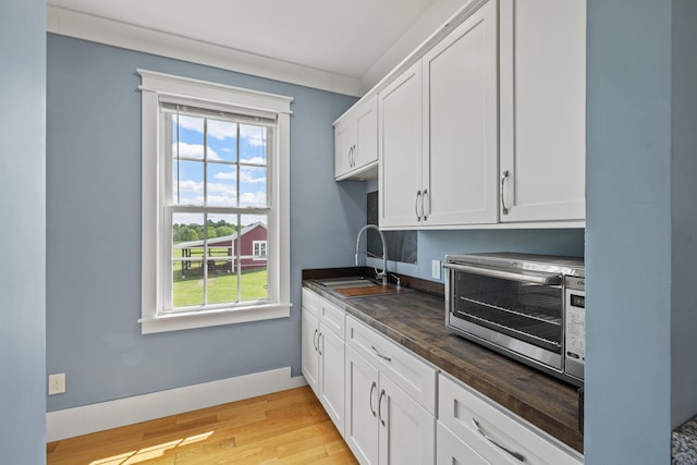324 Hays Mays Rd, Perryville, KY 40468 - kitchen featuring a sink, wooden counters, light wood-style floors, white cabinetry, and stainless steel microwave