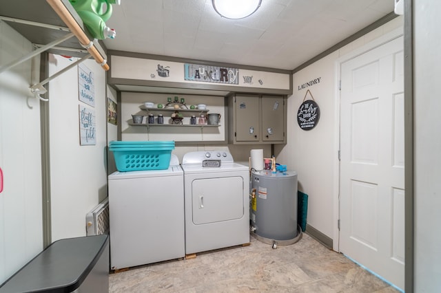 washroom with washer and dryer, cabinet space, and water heater