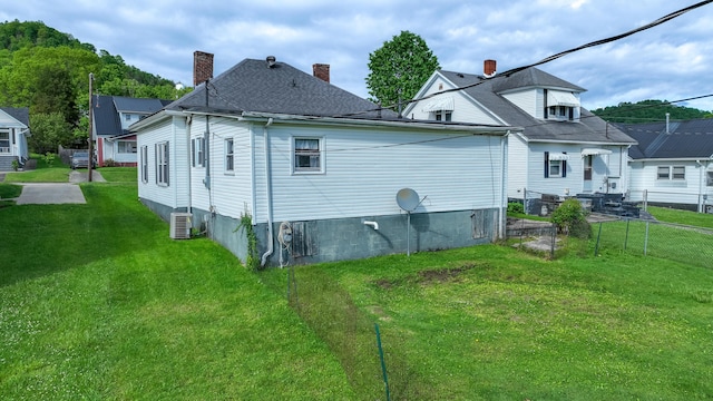rear view of house featuring central air condition unit