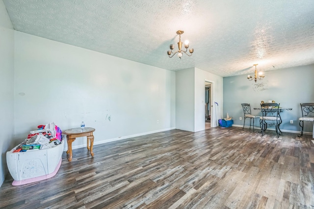 3202 W Cumberland Ave, Middlesboro, KY 40965 - dining room featuring a chandelier, wood finished floors, a textured ceiling, and baseboards