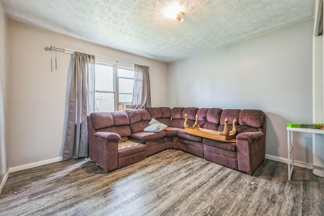 3202 W Cumberland Ave, Middlesboro, KY 40965 - living area with wood finished floors, a textured ceiling, and baseboards