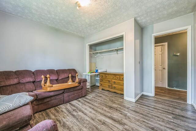 3202 W Cumberland Ave, Middlesboro, KY 40965 - living room with wood finished floors, baseboards, and a textured ceiling
