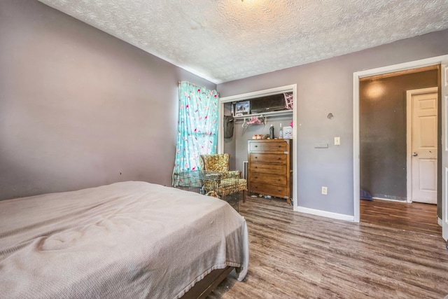 3202 W Cumberland Ave, Middlesboro, KY 40965 - bedroom with wood finished floors, baseboards, a textured ceiling, and a closet
