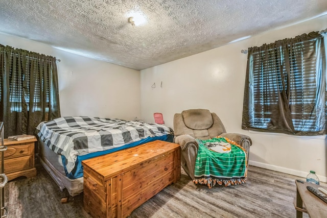 3202 W Cumberland Ave, Middlesboro, KY 40965 - bedroom with wood finished floors, a textured ceiling, and baseboards
