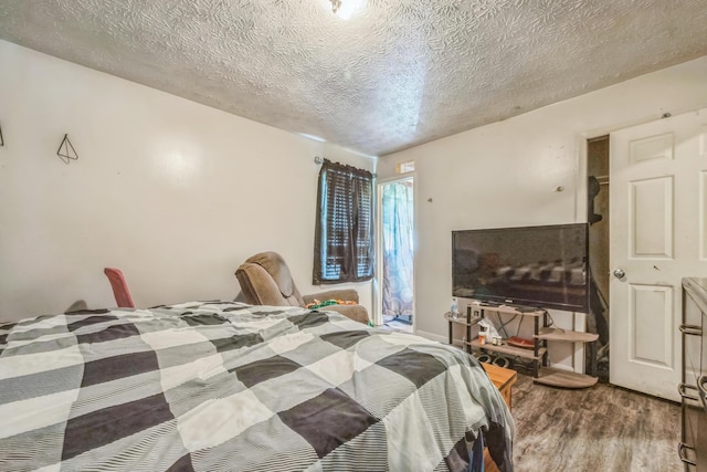 3202 W Cumberland Ave, Middlesboro, KY 40965 - bedroom with wood finished floors and a textured ceiling