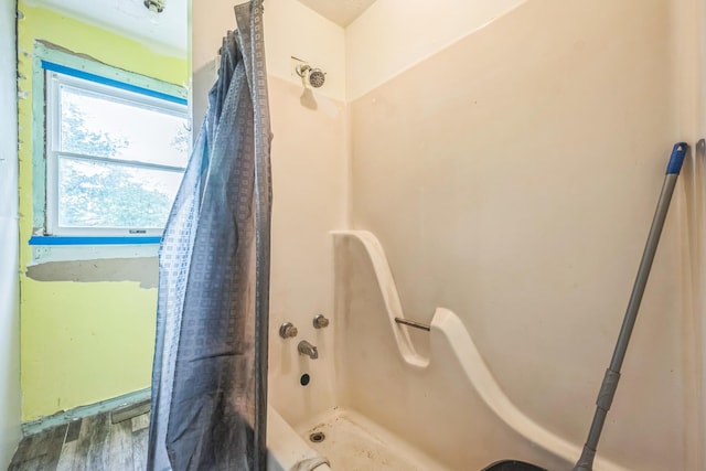 3202 W Cumberland Ave, Middlesboro, KY 40965 - bathroom with wood finished floors and shower / bathtub combination