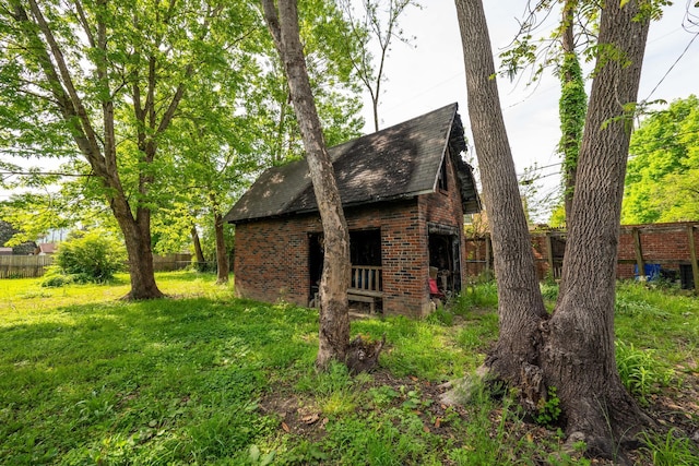 3202 W Cumberland Ave, Middlesboro, KY 40965 - view of side of home featuring brick siding, fence, and an outdoor structure