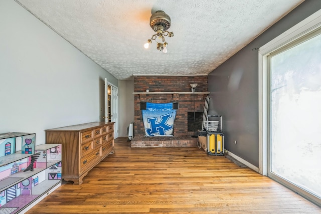 3202 W Cumberland Ave, Middlesboro, KY 40965 - living area with a textured ceiling, wood finished floors, and radiator heating unit