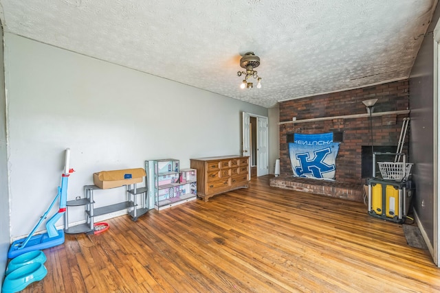3202 W Cumberland Ave, Middlesboro, KY 40965 - living area featuring hardwood / wood-style flooring, a textured ceiling, and baseboards