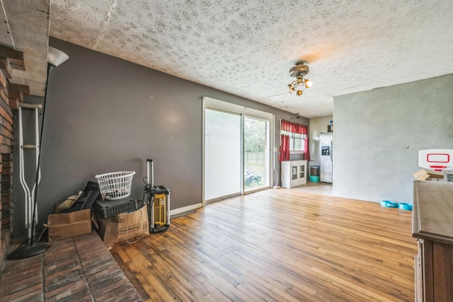 3202 W Cumberland Ave, Middlesboro, KY 40965 - living room with hardwood / wood-style floors, a textured ceiling, and baseboards