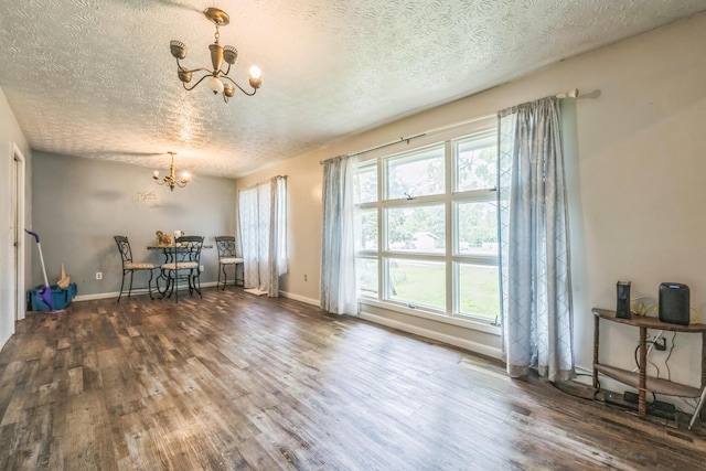 3202 W Cumberland Ave, Middlesboro, KY 40965 - dining area with a chandelier, a textured ceiling, wood finished floors, and baseboards