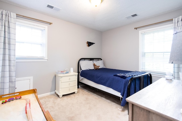 3476 Grasmere Dr, Lexington, KY 40503 - bedroom featuring multiple windows, light carpet, baseboards, and a textured ceiling