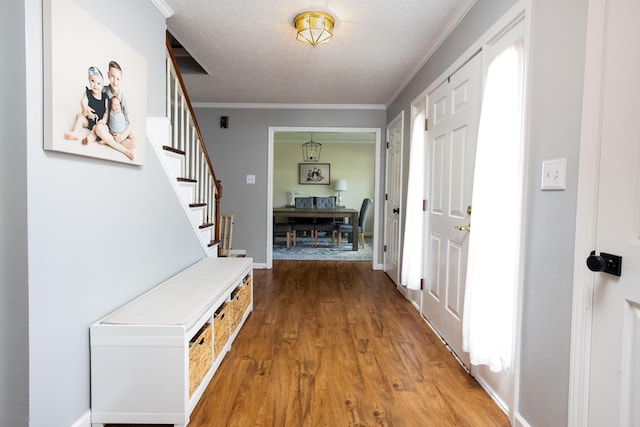 3476 Grasmere Dr, Lexington, KY 40503 - entrance foyer featuring light wood-type flooring, stairs, crown molding, baseboards, and a textured ceiling