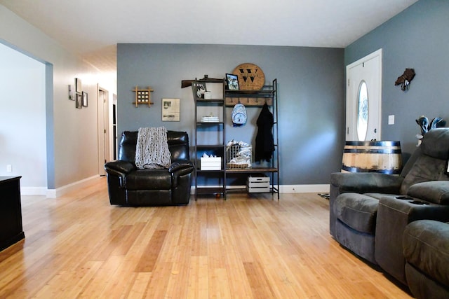 living area with wood finished floors and baseboards