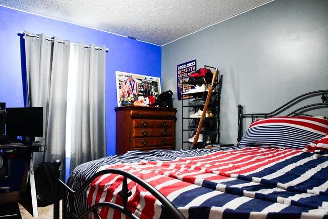 bedroom with carpet flooring and a textured ceiling