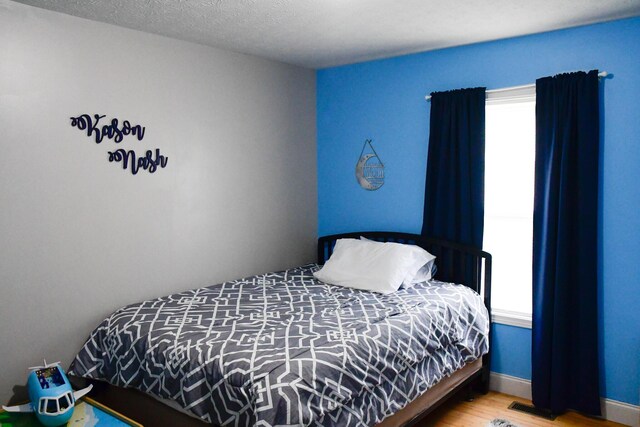 bedroom featuring wood finished floors