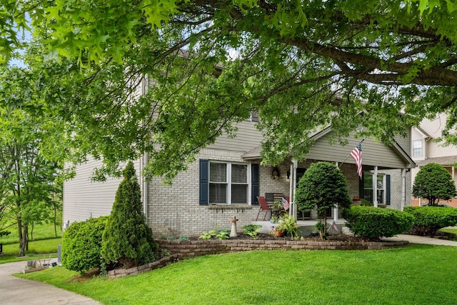 129 Bay Hill Dr, Winchester, KY 40391 - obstructed view of property with brick siding, a front yard, and a patio area