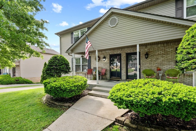 129 Bay Hill Dr, Winchester, KY 40391 - view of front of house featuring covered porch, brick siding, and a front lawn