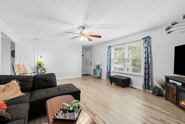129 Bay Hill Dr, Winchester, KY 40391 - living room with light wood-style floors, a textured ceiling, ceiling fan, and baseboards