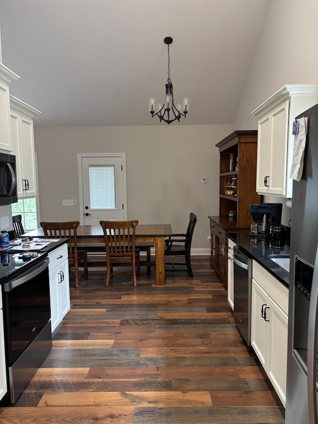 875 Ridgeview Dr, Frankfort, KY 40601 - kitchen with appliances with stainless steel finishes, dark countertops, a chandelier, dark wood-type flooring, and white cabinets