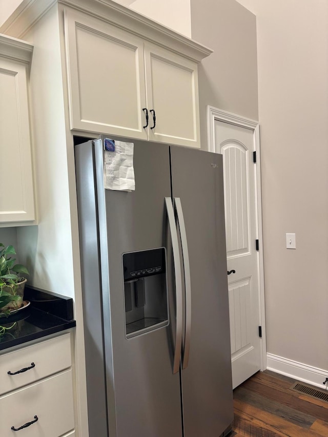 875 Ridgeview Dr, Frankfort, KY 40601 - kitchen with stainless steel refrigerator with ice dispenser, dark countertops, dark wood finished floors, baseboards, and white cabinetry