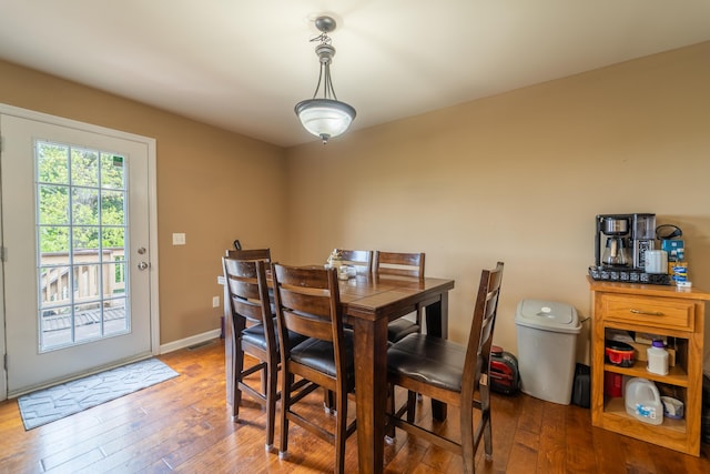 dining room featuring hardwood / wood-style flooring and baseboards