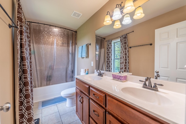 bathroom featuring tile patterned flooring, double vanity, toilet, shower / tub combo with curtain, and a chandelier