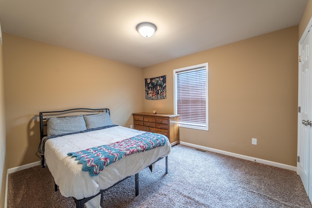 carpeted bedroom featuring baseboards