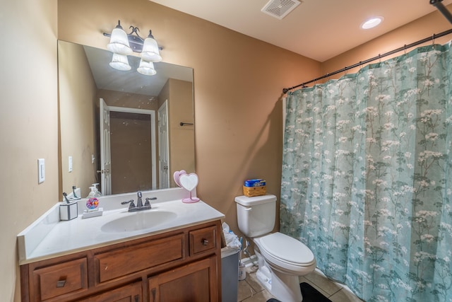 bathroom with tile patterned floors, toilet, vanity, and curtained shower
